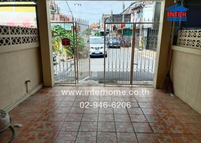 View of the exterior gate and entrance area of a residential property with tiled flooring