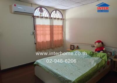 Bedroom with a bed, air conditioning unit, and window with curtains