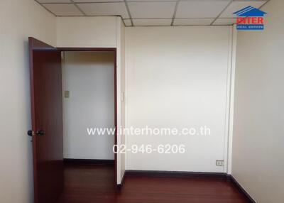 Empty room with wooden floor and open door