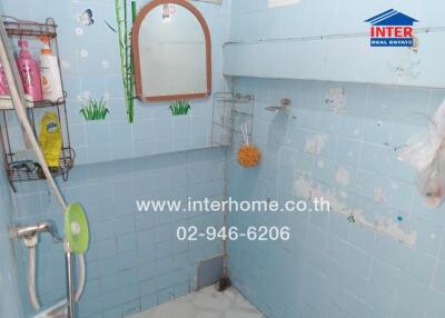 Small bathroom with blue tiles and shower