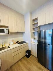 Modern kitchen with wooden cabinets and stainless steel appliances