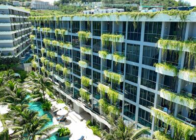 Modern multi-story building with greenery and swimming pool