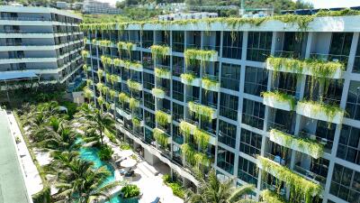 Modern multi-story building with greenery and swimming pool