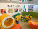 Colorful baby play area with various toys and interactive wall games