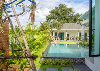 Beautiful outdoor pool area with green surroundings and modern architecture