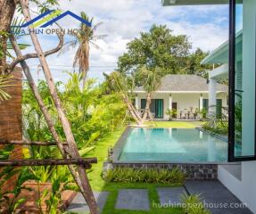 Beautiful outdoor pool area with green surroundings and modern architecture