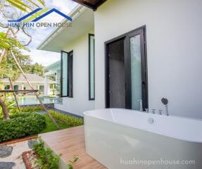 Outdoor area with bathtub and green garden