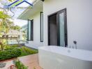 Outdoor area with bathtub and green garden