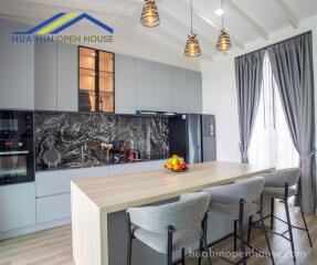 Modern kitchen with island and high stools