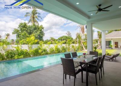 Spacious outdoor patio with dining area and swimming pool