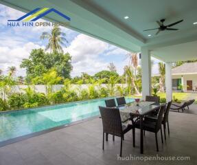 Spacious outdoor patio with dining area and swimming pool