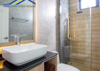 Modern bathroom with a vessel sink and glass shower enclosure