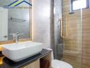 Modern bathroom with a vessel sink and glass shower enclosure