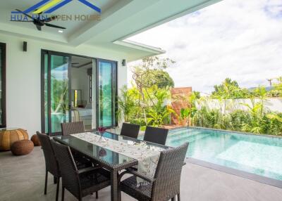 Outdoor patio with dining table and swimming pool