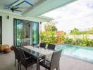 Outdoor patio with dining table and swimming pool