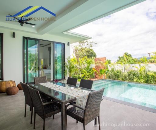 Outdoor patio with dining table and swimming pool