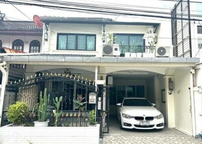 Two-story house with garage and garden