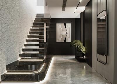 Modern building lobby with marble flooring and illuminated staircase