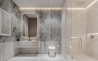 Modern bathroom with marble walls and glass shower