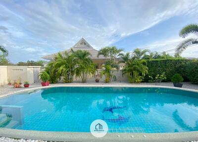 View of swimming pool with surrounding greenery in a residential property