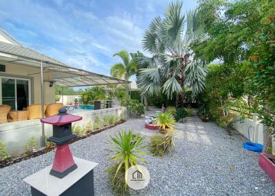 Outdoor garden with various plants and a small Japanese-style lantern