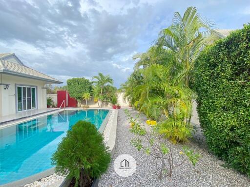 Outdoor area with swimming pool and lush greenery