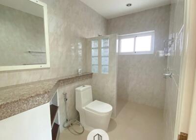 Modern bathroom with granite countertop and large mirror