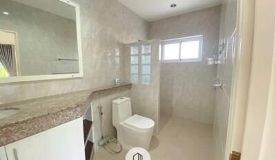 Modern bathroom with granite countertop and large mirror