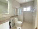 Modern bathroom with granite countertop and large mirror