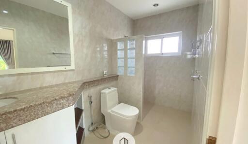 Modern bathroom with granite countertop and large mirror