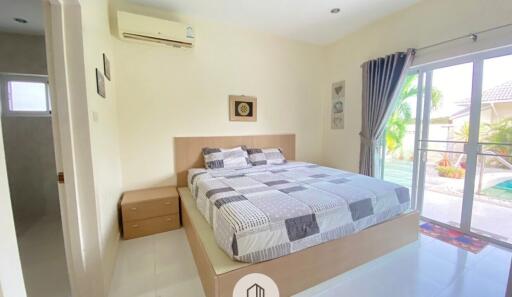 Master bedroom with large bed and balcony access