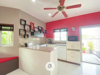 Modern kitchen with ceiling fan and natural light