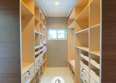 Spacious walk-in closet with shelves and drawers