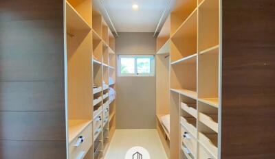 Spacious walk-in closet with shelves and drawers