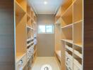 Spacious walk-in closet with shelves and drawers