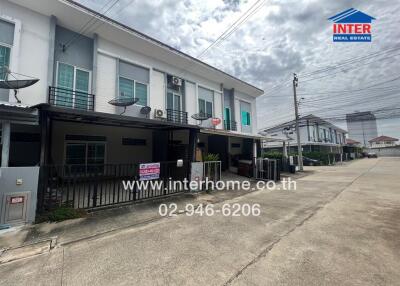 Front view of modern townhouse with driveway and street