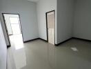 Bedroom with tiled floor and door leading to another room