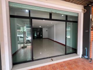 Modern storefront with large glass windows and tiled flooring