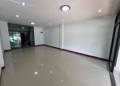 Spacious unfurnished room with tiled floor and glass doors