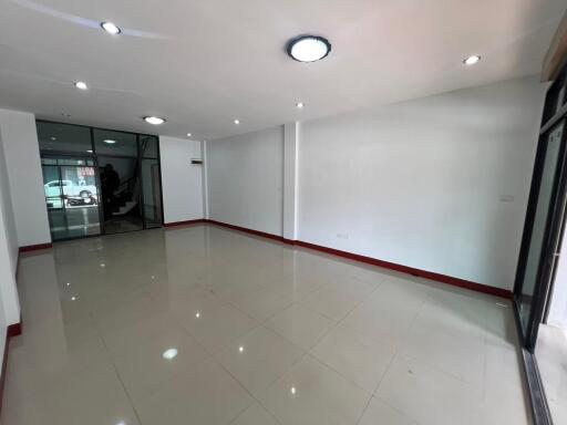 Spacious unfurnished room with tiled floor and glass doors