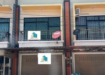 Two-story commercial building with signage and a balcony