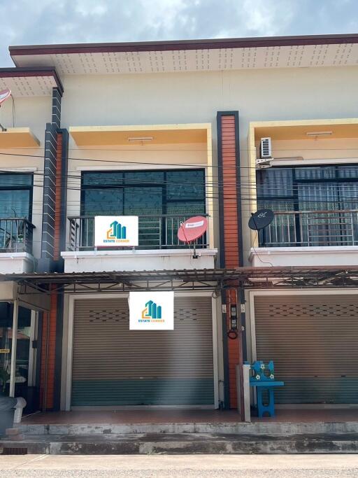 Two-story commercial building with signage and a balcony