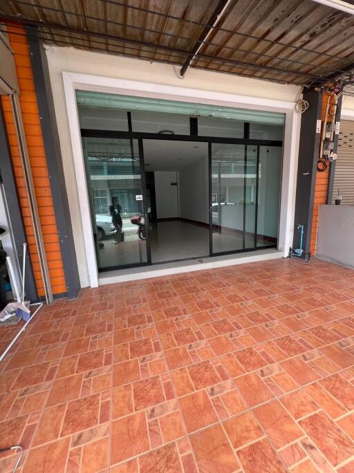 Front view of a building with sliding glass doors and tiled flooring