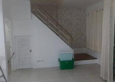 Spacious living room with stairs leading to the second floor