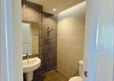 Modern bathroom with a sink, toilet, and shower