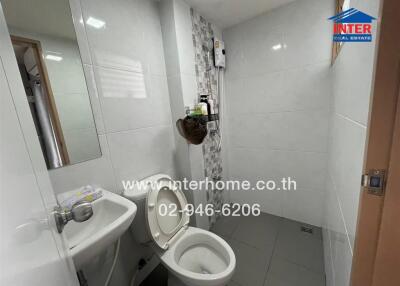 Modern bathroom with white tiles and toilet