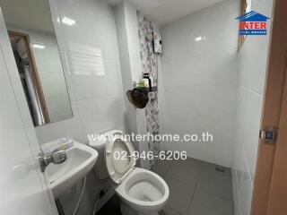 Modern bathroom with white tiles and toilet