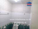 Bathroom with wall-mounted mirror, toilet, and tiled walls