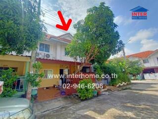 Two-story house with exterior view and surrounding greenery