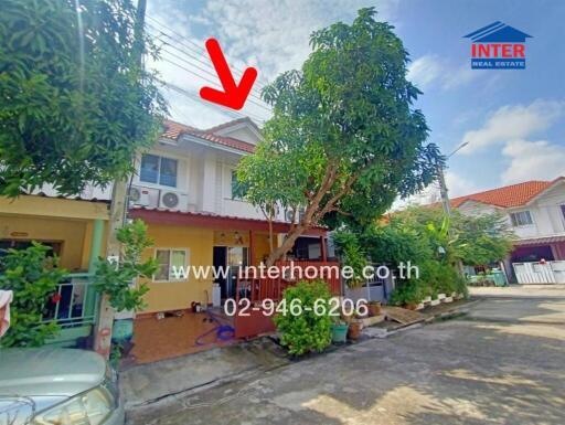 Two-story house with exterior view and surrounding greenery